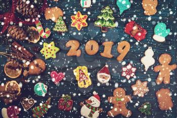 Gingerbreads cookies for new 2019 year holiday on wooden background, xmas theme