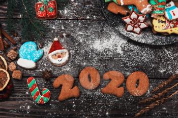 Different ginger cookies for new 2020 year holiday on wooden background, xmas theme