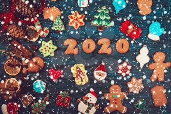 Gingerbreads cookies for new 2020 year holiday on wooden background, xmas theme