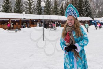 BYURIZOVAYA KATUN. ALTAISKIY KRAI. WESTERN SIBERIA. RUSSIA - DECEMBER 1, 2018: Snow Maiden girl in the Altaiskaya Zimovka holiday - the first day of winter on December 1, 2018 in Altayskiy krai, Siberia, Russia.