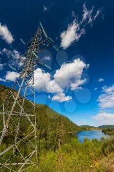 Power lines in the beautiful mountain landscape in Altai, Siberia, Russia.