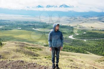 Man watching to glacier in Altai mountains. Resting in mountains or global warming concept