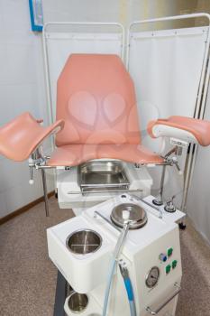Gynecological cabinet with chair and other medical equipment in modern clinic