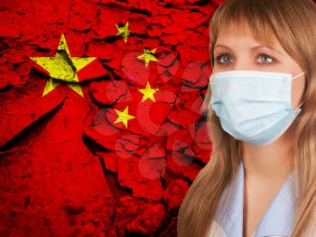 Female doctor with medical mask on China flag background. Concept of corona virus.