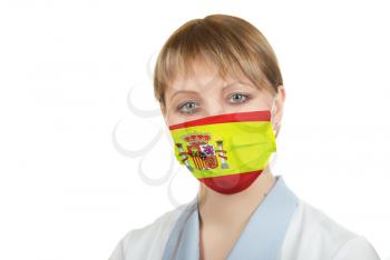 Closeup of a female healthcare professional nurse wearing a protection mask with Spain flag