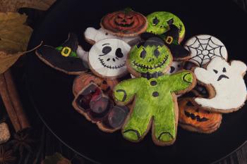 Delicious ginger cookies for Halloween on wooden table