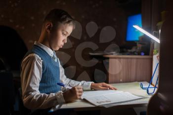 The pupil boy does his homework