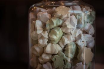 Marshmallows in glass jar, closeup photo