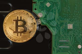 Bitcoin coin on the HDD background