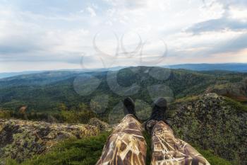 Man resting in the mountains, pov view