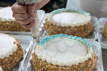 Manual cakes production on factory