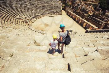 Young woman and her son at theatre in Myra ancient city of Antalya in Turkey.