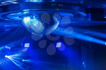 Disco ball with bright rays, night party or concert background