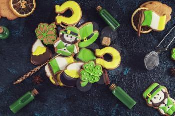Homemade gingerbreads cookies for Patrick's day on dark background