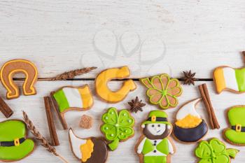 Gingerbreads cookies for Patrick's day on white wooden background with copyspace