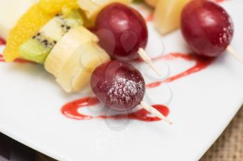 Food snack: cheese with grapes, kiwi, orange and banana