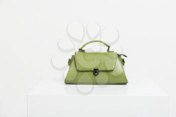 Green fashion female handbag on white background