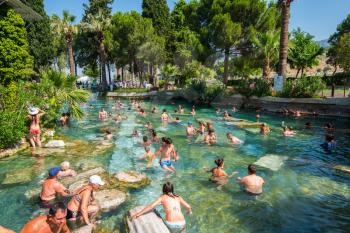 Pammukale, Turkey- July, 2015: Tourists swim in antique Cleopatra pool. Color of water is caused by the presence of a large amount of radon.