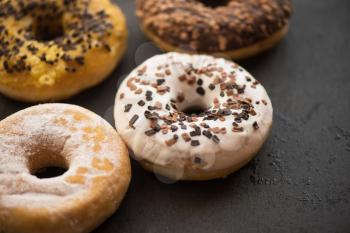 Assorted donuts with chocolate, glaze and sprinkles