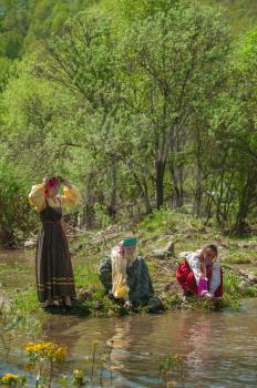 TOPOLNOE, ALTAY, RUSSIA - May 27, 2018: Folk festivities dedicated to the feast of the Holy Trinity. Ancient Russian rite: girls are sinking their birch wreaths