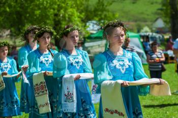 TOPOLNOE, ALTAY, RUSSIA - May 27, 2018: Folk festivities dedicated to the feast of the Holy Trinity. Happy young girls in traditional dress with handmade towels