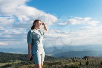 Domestic tourism, travel, lesure and freedom concept after pandemic- woman on the top of Altai mountain, beauty summer evening landcape
