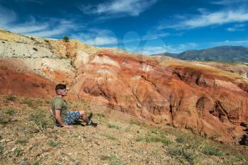 Relaxing man in Valley of Mars landscapes in the Altai Mountains, Kyzyl Chin, Siberia, Russia