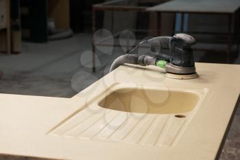 Stone sink furniture production. Grinder for polishing the surface of the sink