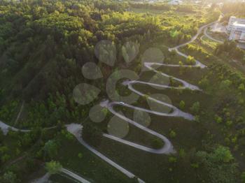 Aerial top vew of winding road in the city, drone shot