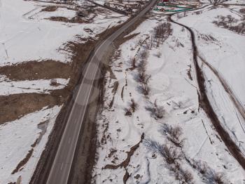 Aerial view of a road in winter landscape of Altai mountains
