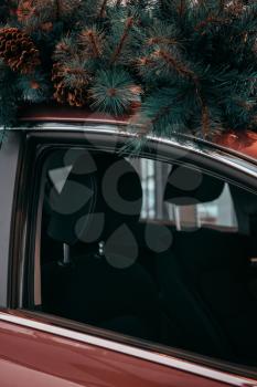 Car with christmas tree on roof, new year concept or preparing for christmas or car sale at car dealership and new year car discount sale