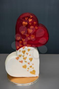 Wedding cake as two hearts on grey background