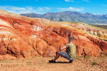 Relaxing man in Valley of Mars landscapes in the Altai Mountains, Kyzyl Chin, Siberia, Russia