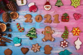 Gingerbread cookies for new 2021 year on wooden background, xmas theme
