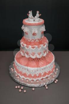 Wedding cake with angels on grey background