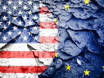 Trade war concept, USA flag against European flag, on dry cracked earth background