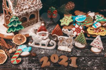 New year 2021 concept: holiday gingerbreads on wooden background, xmas and christmas theme
