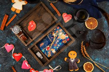 Wooden photo box with photo for Valentine's Day or Wedding Day. Decorated with gingerbreads. Romantic or love concept. Gingerbreads for Valentines Day on dark concrete background