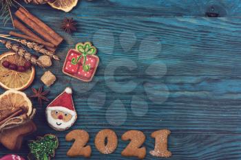 New year 2021 concept: holiday gingerbreads on wooden background, xmas and christmas theme