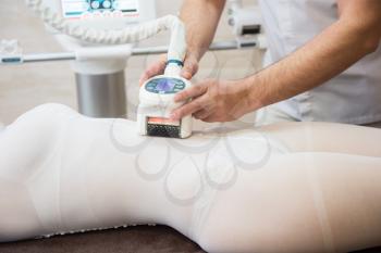 Procedure laser lipolysis of the abdominal region in a beauty center.