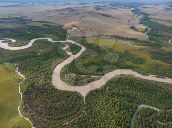 Aerial view of Kurai steppe and Chuya river on North-Chui ridge background. Altai mountains, Russia.