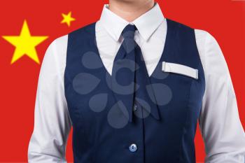 Service woman uniform, closeup photo on a China flag background