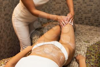 Woman having massage with cream at spa, closeup photo. Beauty, healthy lifestyle and relaxation concept.