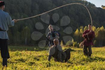 CHARISHSKOE. ALTAISKIY KRAI. WESTERN SIBERIA. RUSSIA - SEPTEMBER 15, 2016: descendants of the Cossacks in the Altai, cossacks play in ancient Slavic national game: rope jumping at the festival on September 15, 2016 in Altayskiy krai, Siberia, Russia.