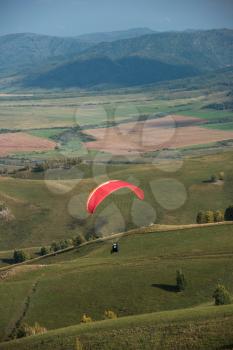 Paragliding in the mountains. Paragliders in fight in the mountains, extreme sport activity.