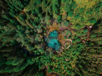 Beautiful Geyser lake with thermal springs that periodically throw blue clay and silt from the ground. Aerial dron view, Altai mountains, Russia