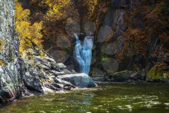 Korbu Waterfall at Lake Teletskoye in autumn Altai Mountains. The most famous lake waterfall