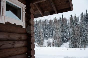 Winter house in forest. Clean air, rest and relaxation. Unity with nature. View from the porch to the forest