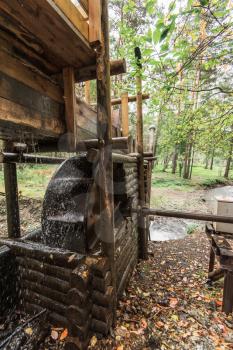 Rustic watermill with wheel being turned by force of falling water from Altai mountain river.