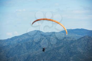 Paragliding in Altai mountains. Paragliders in fight in the mountains, concept of extreme sport activity.